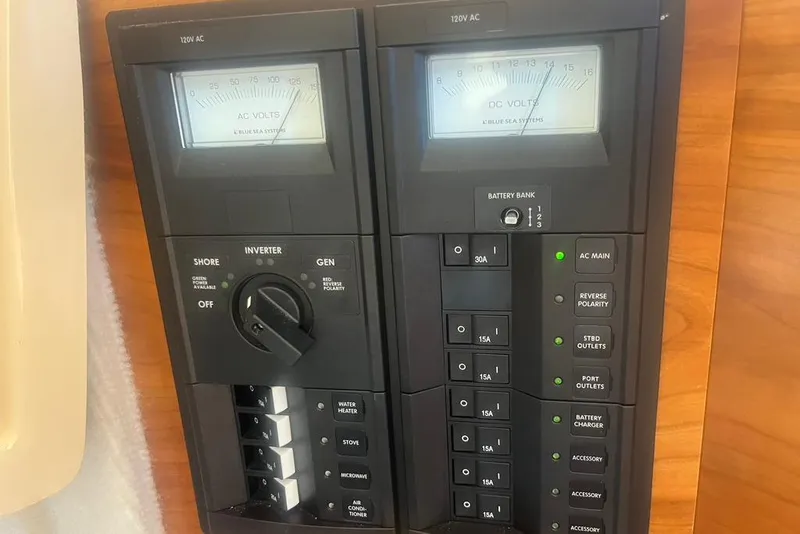 Slide: The Image of Electrical control panel on a 2013 Cutwater C-28 boat, featuring AC and DC volt meters. - 10