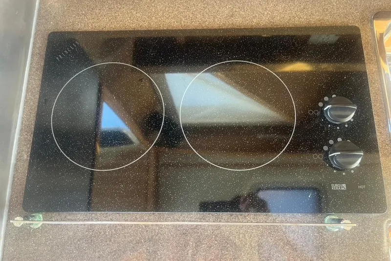 Slide: The Image of Ceramic cooktop with dual burners and control knobs on a 2013 Cutwater C-28 boat. - 12