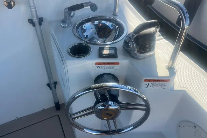Slide: The Image of Steering console of a 2013 Cutwater C-28 boat with controls and sink. - 16