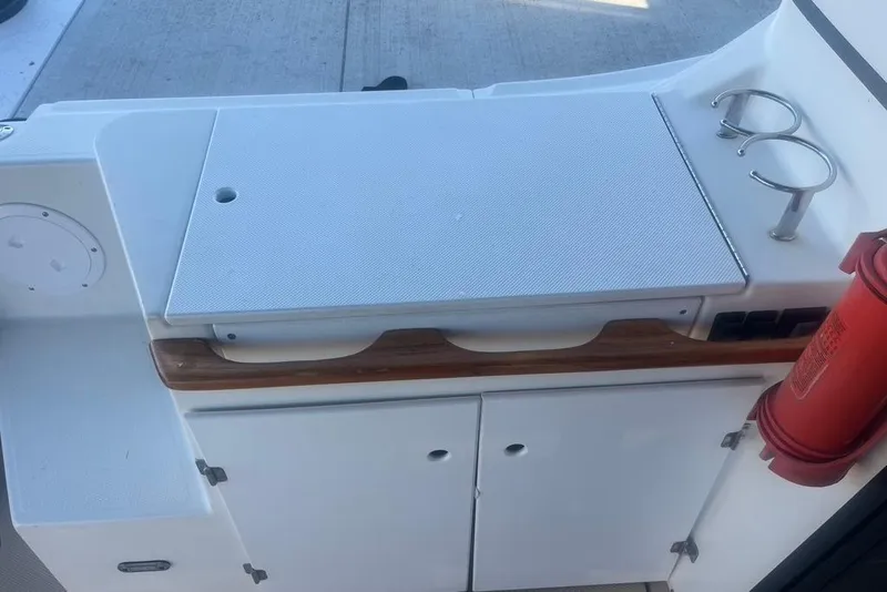 Slide: The Image of 2013 Cutwater C-28 boat interior with storage cabinets and cup holders. - 17