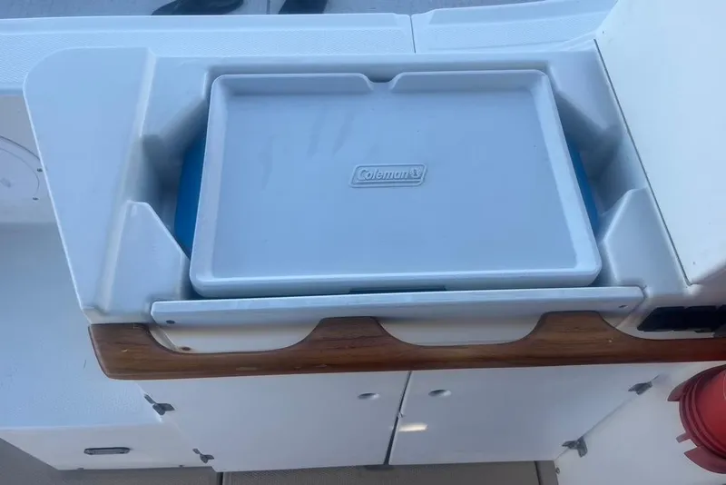 Slide: The Image of Cutwater C-28 2013 boat interior with Coleman cooler in storage compartment. - 18