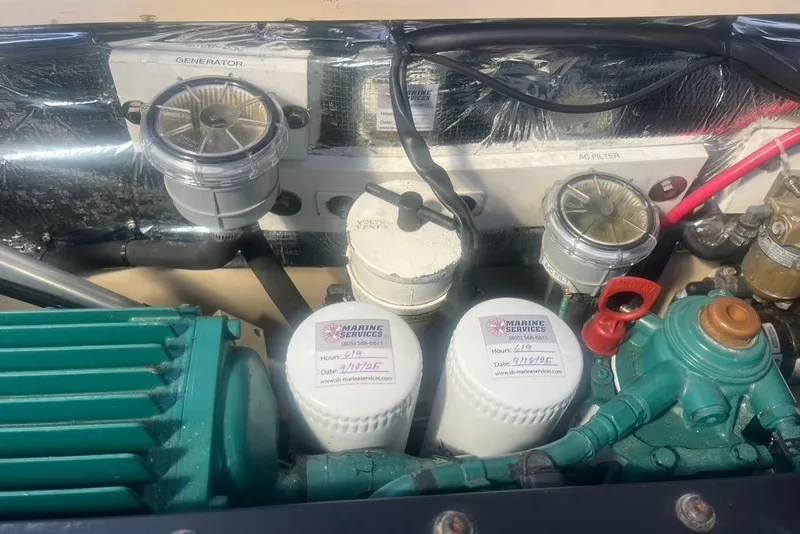 Slide: The Image of Engine compartment of a 2013 Cutwater C-28 boat with visible filters and components. - 21