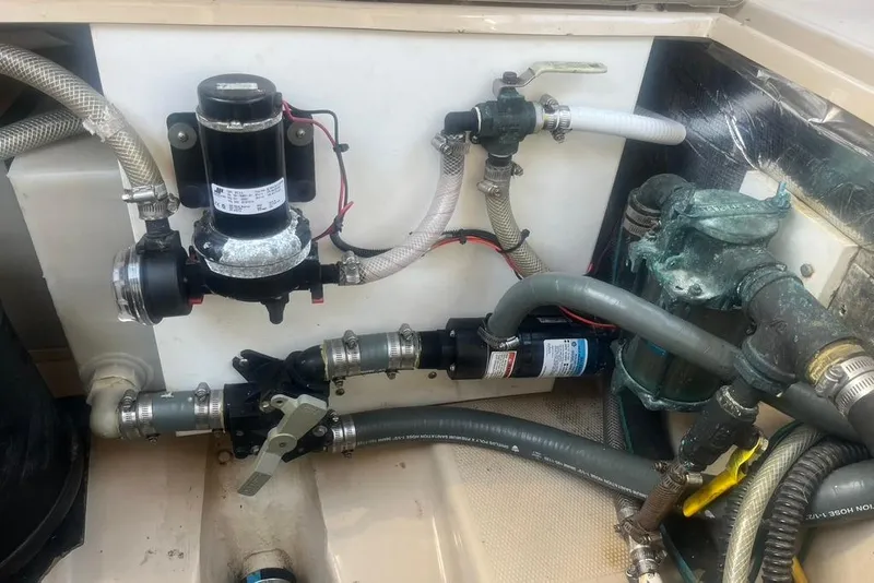 Slide: The Image of 2013 Cutwater C-28 boat plumbing system with hoses, valves, and pump components. - 22