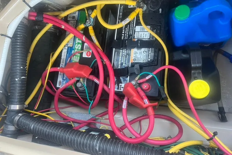 Slide: The Image of Battery compartment of a 2013 Cutwater C-28 boat with cables and containers. - 24