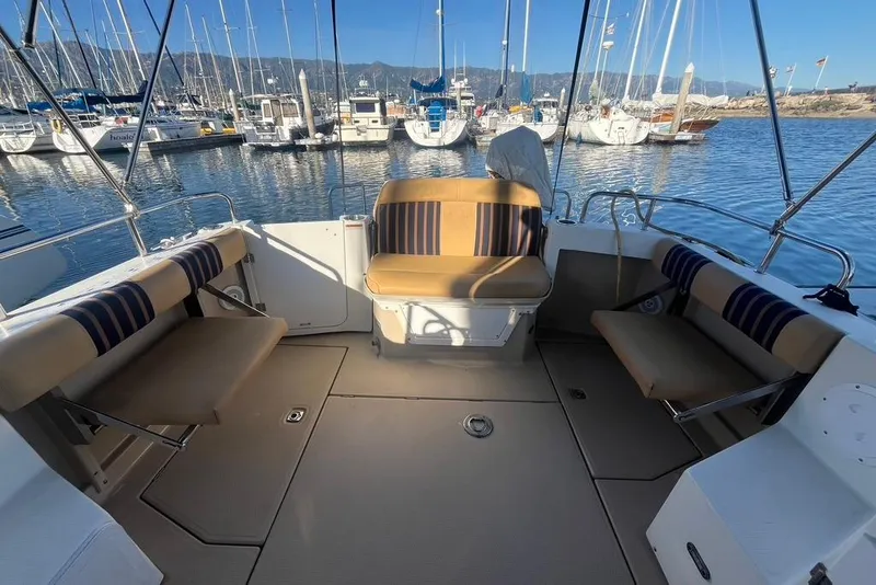 Slide: The Image of 2013 Cutwater C-28 boat interior with striped seating, docked in a marina. - 25