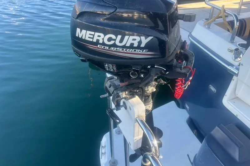 Slide: The Image of Mercury FourStroke engine on a 2013 Cutwater C-28 boat, docked on calm water. - 28
