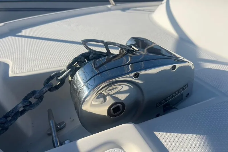 Slide: The Image of Anchor windlass on 2013 Cutwater C-28 boat deck, featuring a sturdy chain mechanism. - 32