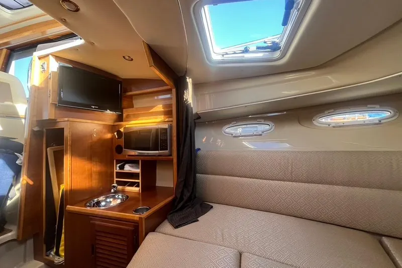 Slide: The Image of Interior of 2013 Cutwater C-28 boat with kitchenette, TV, and seating area. - 37
