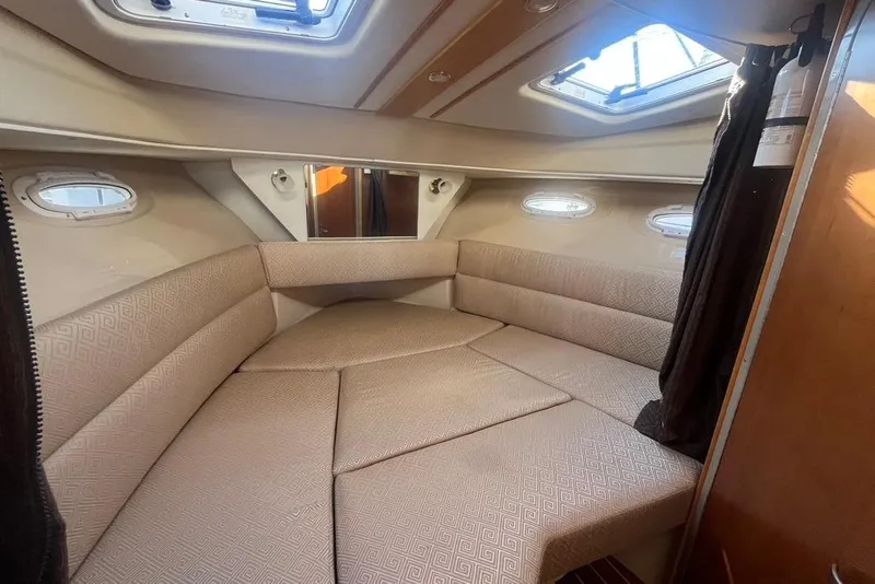 Slide: The Image of Interior cabin of a 2013 Cutwater C-28 boat with beige seating and windows. - 38