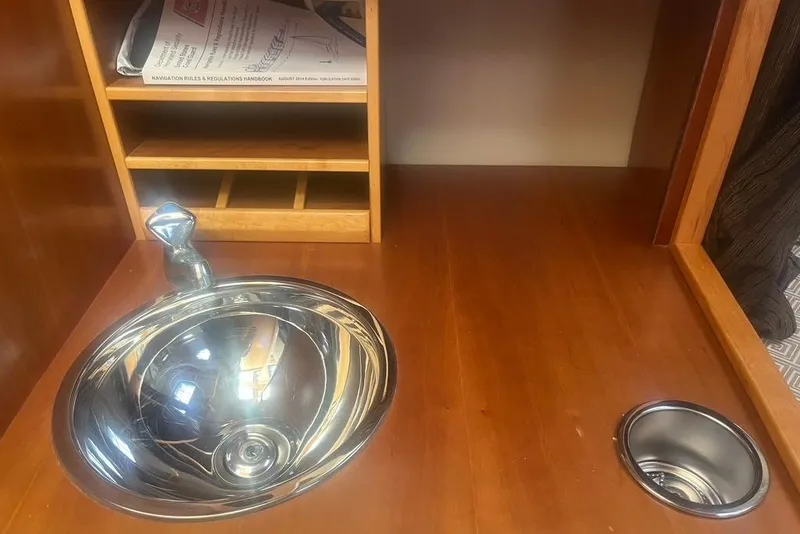 Slide: The Image of 2013 Cutwater C-28 interior with wooden cabinetry and stainless steel sink. - 40