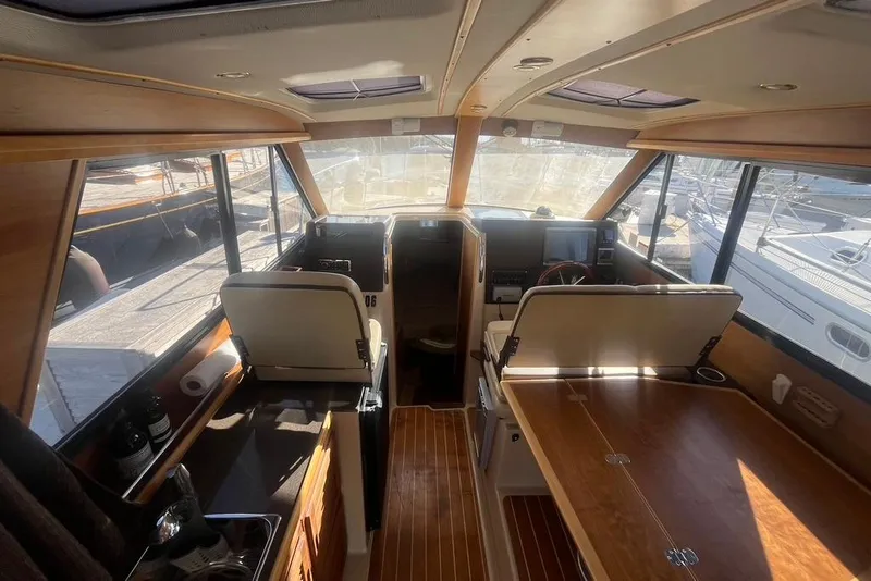 Slide: The Image of Interior of a 2013 Cutwater C-28 boat with wooden finishes and seating. - 43