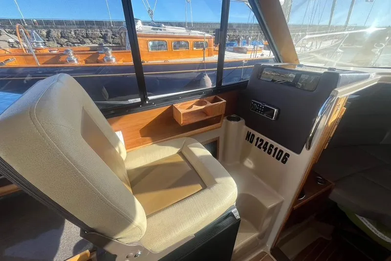Slide: The Image of Interior of 2013 Cutwater C-28 boat with helm seat and dashboard view. - 49
