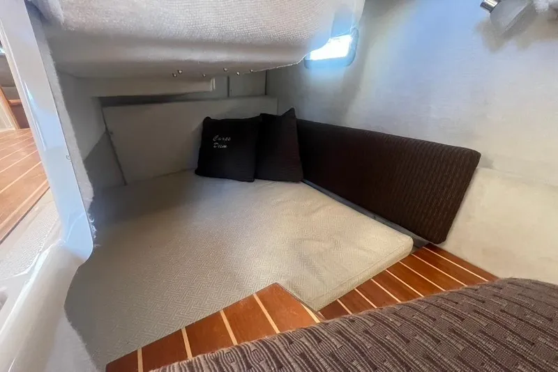 Slide: The Image of Cozy interior cabin of 2013 Cutwater C-28 boat with cushions and wooden flooring. - 8