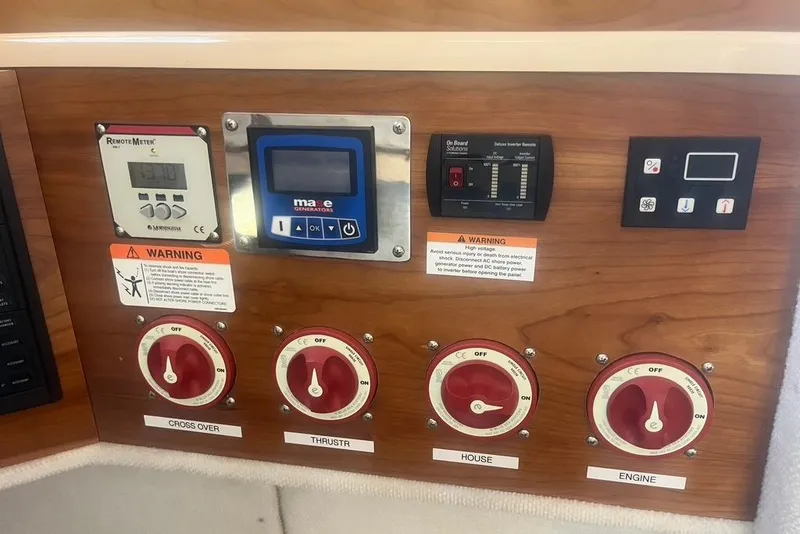 Slide: The Image of Control panel of a 2013 Cutwater C-28 boat with various switches and meters. - 9
