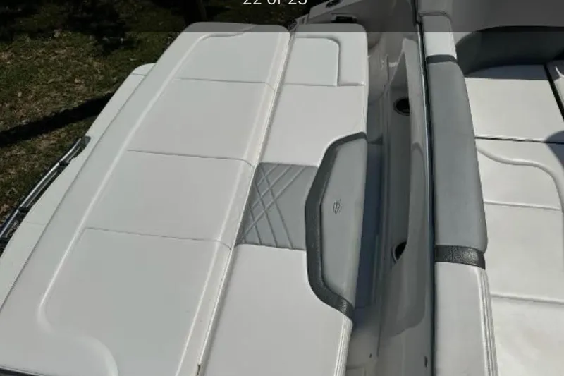 Slide: The Image of 2018 Chaparral 307 SSX boat interior with white and gray seating. - 13