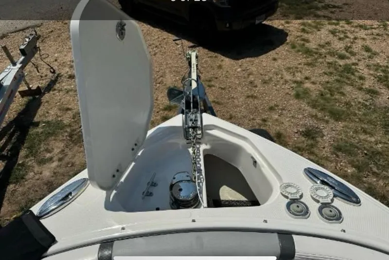 Slide: The Image of 2018 Chaparral 307 SSX boat anchor compartment with open hatch and chain. - 14