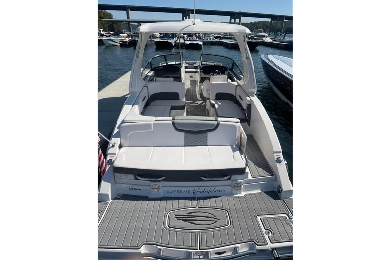 Slide: The Image of 2018 Chaparral 307 SSX boat docked, featuring spacious seating and sleek design. - 17