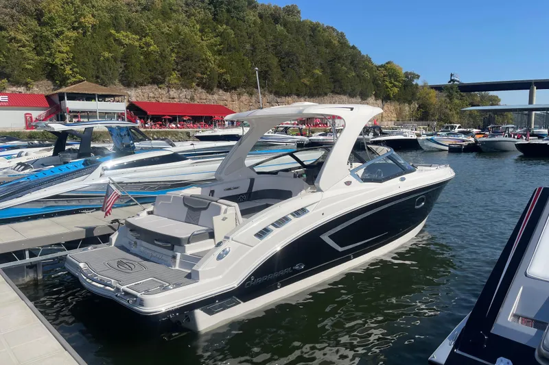 Slide: The Image of 2018 Chaparral 307 SSX boat docked at a marina with scenic background. - 5
