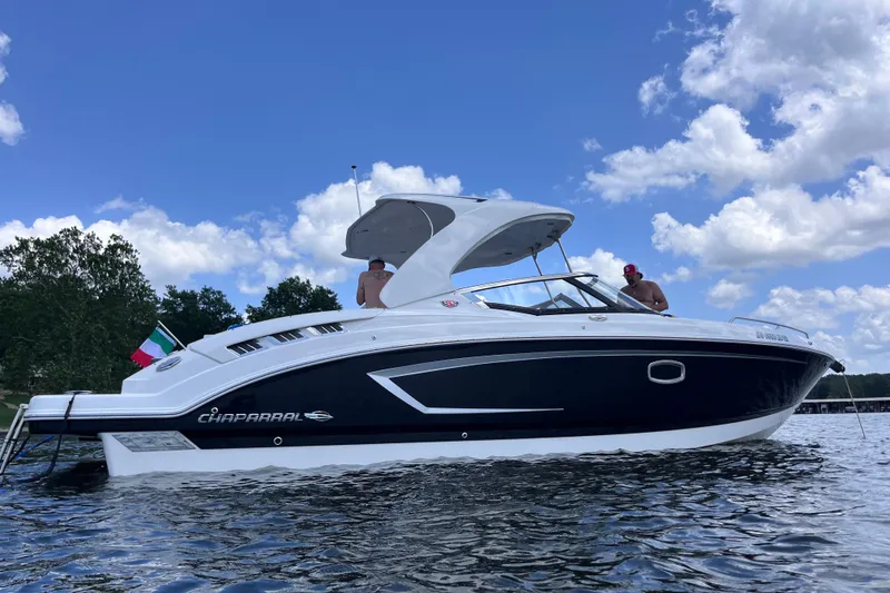 Slide: The Image of 2018 Chaparral 307 SSX boat on water under blue sky with clouds. - 7