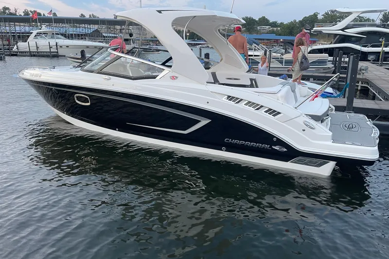 Slide: The Image of 2018 Chaparral 307 SSX boat docked at marina with people onboard. - 8