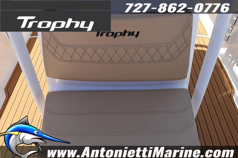 Slide: The Image of 2026 Bayliner Trophy T22CC boat seat with logo, displayed on teak deck. - 12