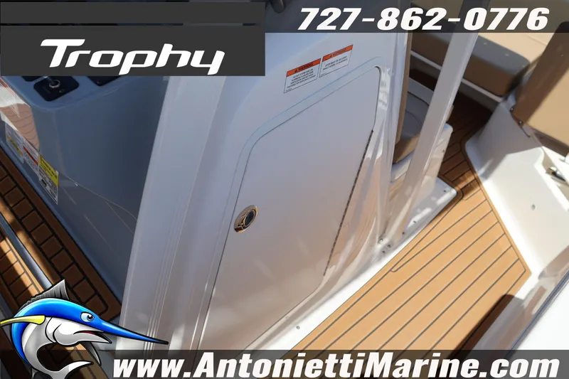 Slide: The Image of 2026 Bayliner Trophy T22CC boat interior with teak flooring and storage compartment. - 17