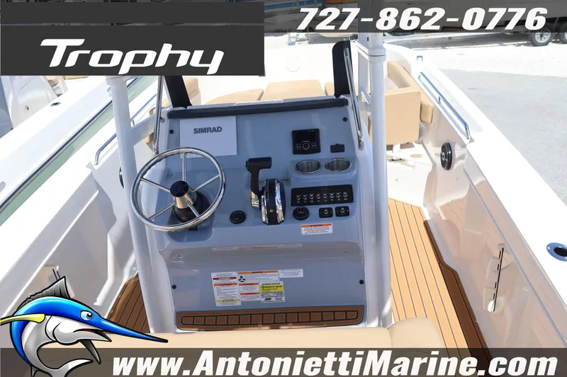Slide: The Image of 2026 Bayliner Trophy T22CC boat dashboard with steering wheel and controls. - 5