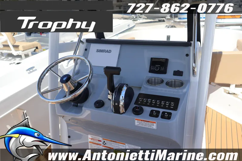 Slide: The Image of 2026 Bayliner Trophy T22CC boat dashboard with steering wheel and controls. - 7