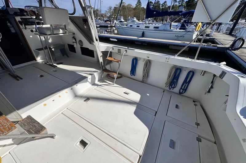 Slide: The Image of 1987 Luhrs Alura 30 boat interior with seating and storage, docked at marina. - 14