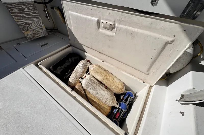 Slide: The Image of Storage compartment on a 1987 Luhrs Alura 30 boat with fenders and equipment. - 20