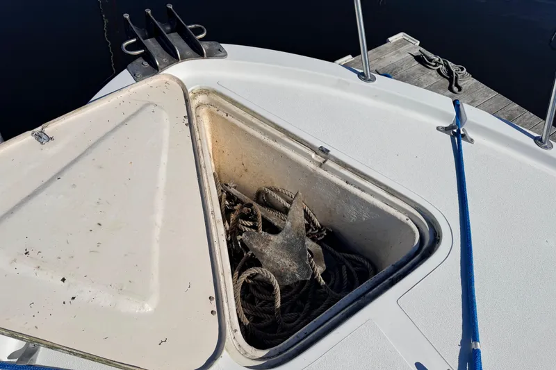 Slide: The Image of Anchor storage compartment on 1987 Luhrs Alura 30 boat, open with visible anchor and ropes. - 21