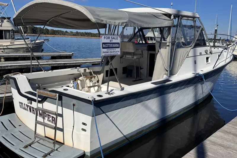 Slide: The Image of 1987 Luhrs Alura 30 boat docked, for sale at McCotters Marina. - 3