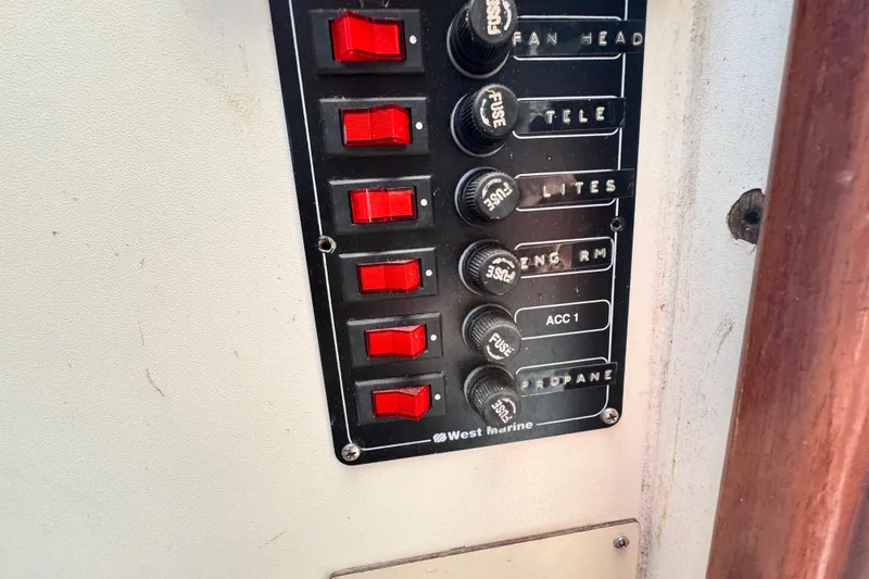 Slide: The Image of Control panel with red switches and fuses on a 1987 Luhrs Alura 30 boat. - 30