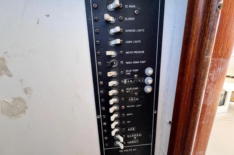 Slide: The Image of Electrical panel of a 1987 Luhrs Alura 30 boat with labeled switches and controls. - 32