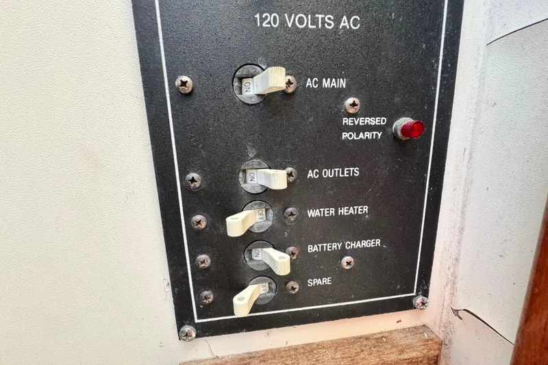 Slide: The Image of Electrical panel of a 1987 Luhrs Alura 30 boat with switches and reversed polarity indicator. - 33