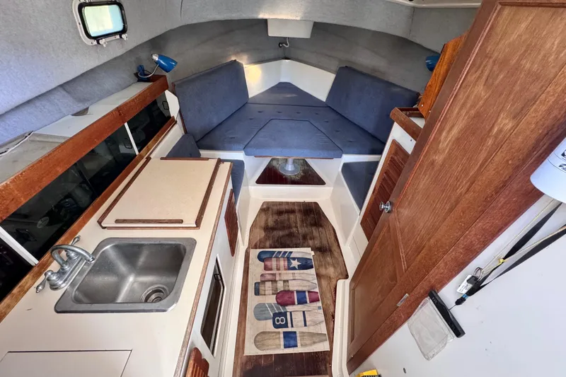 Slide: The Image of Interior of 1987 Luhrs Alura 30 boat with kitchenette and seating area. - 34