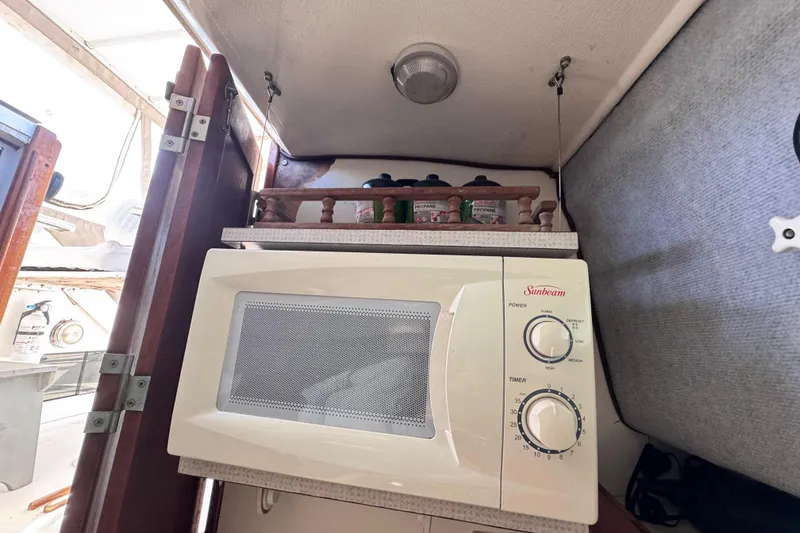 Slide: The Image of Microwave in 1987 Luhrs Alura 30 boat interior, with propane canisters above. - 40