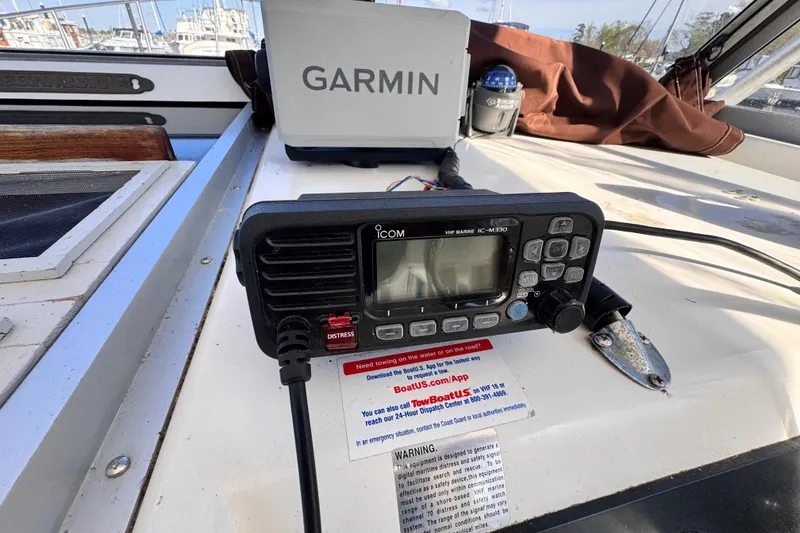 Slide: The Image of VHF marine radio and Garmin device on 1987 Luhrs Alura 30 boat dashboard. - 43