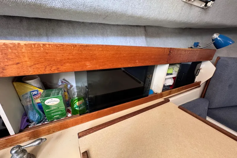 Slide: The Image of Interior of 1987 Luhrs Alura 30 boat with storage and seating area. - 45