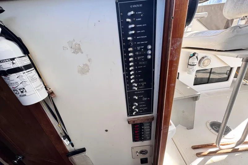 Slide: The Image of 1987 Luhrs Alura 30 boat with control panel and fire extinguisher. - 46