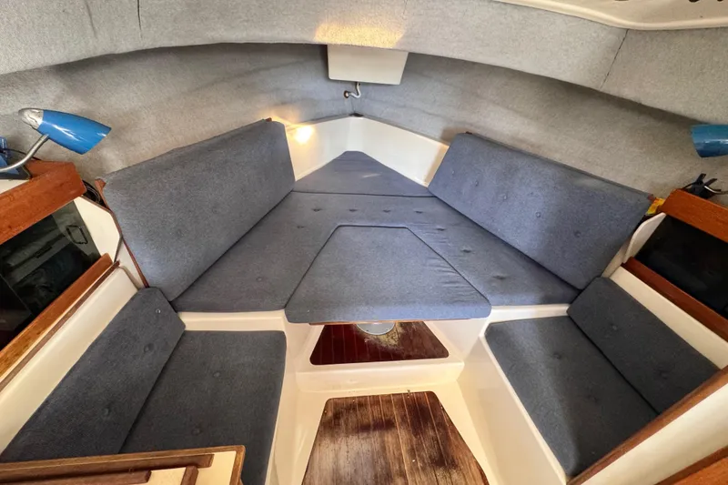 Slide: The Image of Interior cabin of 1987 Luhrs Alura 30 with blue cushions and wooden accents. - 47