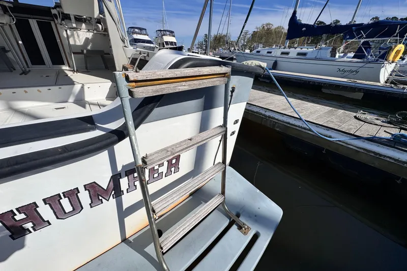 Slide: The Image of 1987 Luhrs Alura 30 boat with ladder at marina dock. - 8