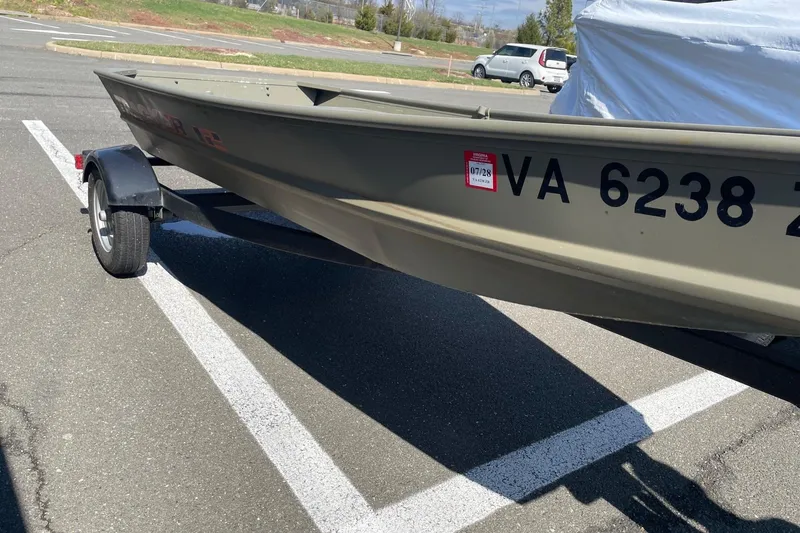 Slide: The Image of 2025 Tracker Grizzly 1236 Jon boat on trailer in parking lot. - 3