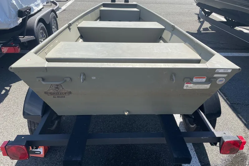 Slide: The Image of 2025 Tracker Grizzly 1236 Jon boat on trailer, parked outdoors. - 6