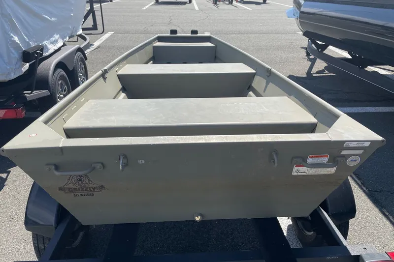 Slide: The Image of 2025 Tracker Grizzly 1236 Jon boat on trailer in parking lot. - 7