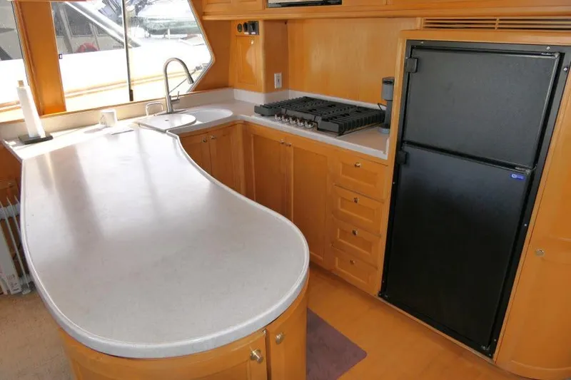 Slide: The Image of Luxurious kitchen in 1999 Hampton 490 Pilothouse yacht with modern appliances. - 11