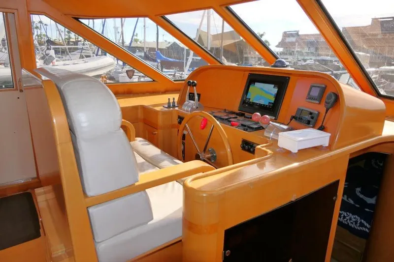 Slide: The Image of Pilothouse interior of 1999 Hampton 490, featuring navigation equipment and helm station. - 17