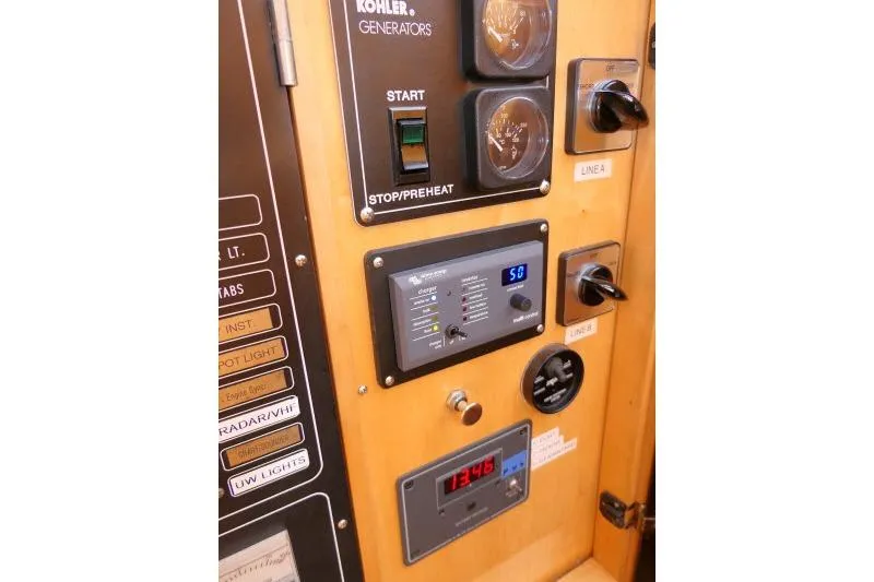 Slide: The Image of Control panel of a 1999 Hampton 490 Pilothouse with generator and electrical switches. - 22