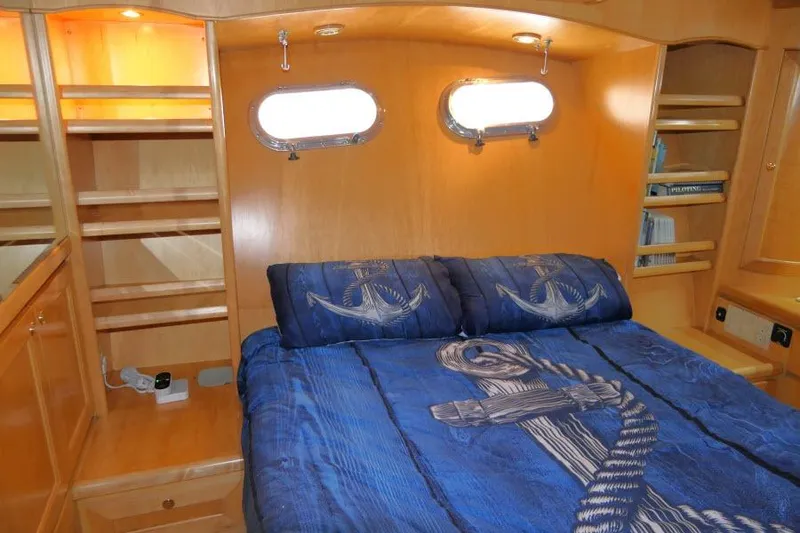 Slide: The Image of Cozy cabin interior of 1999 Hampton 490 Pilothouse with nautical-themed bedding. - 28