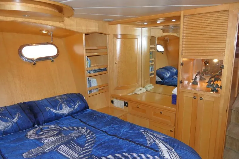 Slide: The Image of Luxurious cabin interior of 1999 Hampton 490 Pilothouse yacht with nautical-themed bedding. - 29